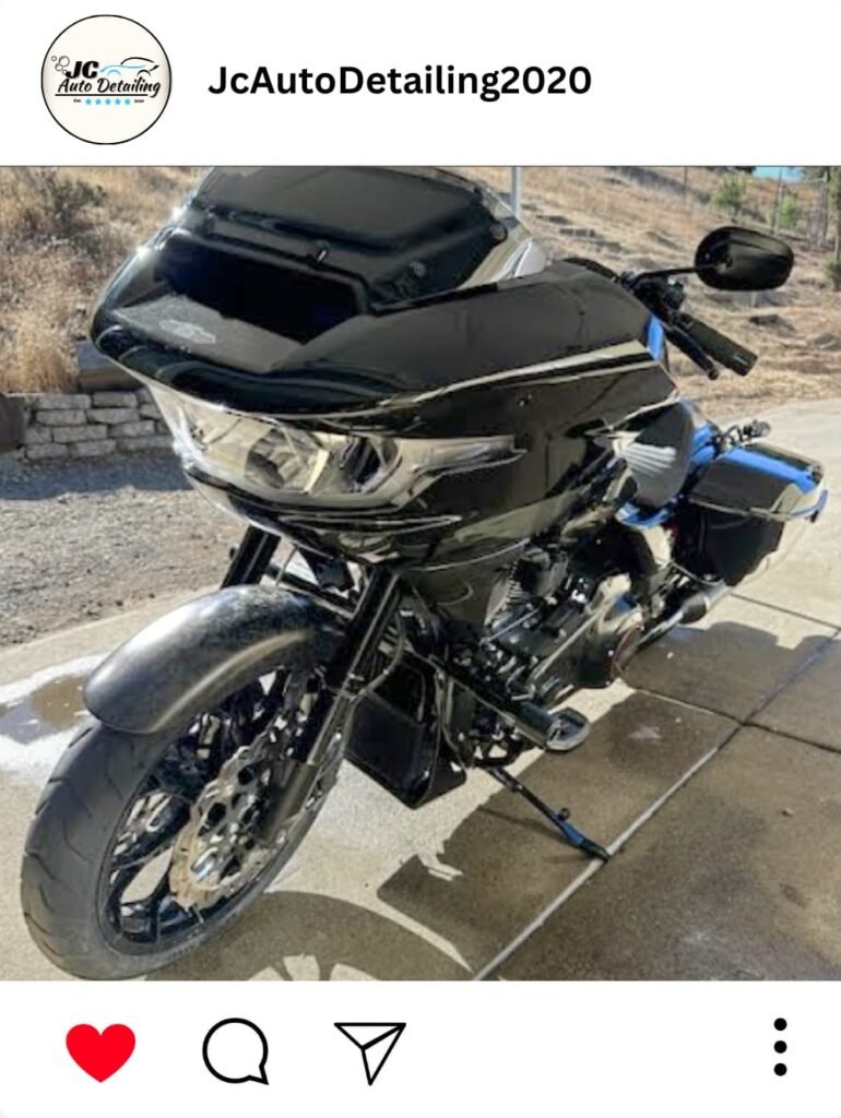 A black Harley-Davidson CVO Road Glide motorcycle, recently detailed, parked in a driveway. The motorcycle has chrome accents and blue detailing.